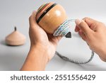 The man playing japanese traditional wooden spinning top.