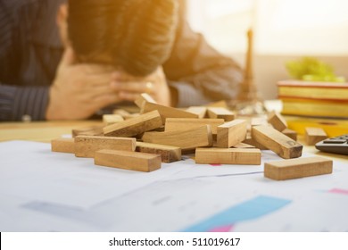 Man Is Playing Jenga,a Wood Blocks Tower Game For Practicing Mental Skill With Business,Exhausted Businessman Falling Asleep At His Office Desk,entrepreneur Background,selective Focus,vintage Color