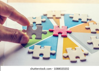 The Man Playing The Jigsaw Puzzle With Graph Summary. Business Concept. Red And White Puzzles.