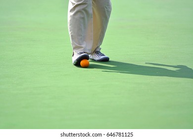 Man Playing Lawn Bowls. Soft Focus On The Blurred Background.