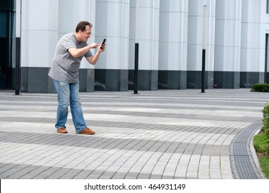 Man playing mobile game at the modern city background