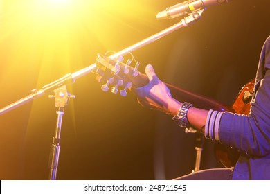 Man Playing Music By Wooden Acoustic Guitar In The Concert Stage