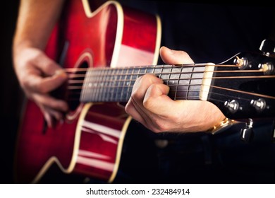 Man Playing Music At Red Wooden Acoustic Guitar