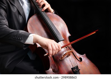 Man Playing On Cello On Dark Background