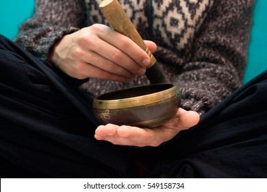 Man playing on a singing bowl - Shutterstock ID 549158734