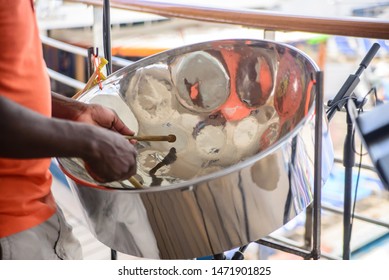 man is playing on a steel drums at cruise ship open deck