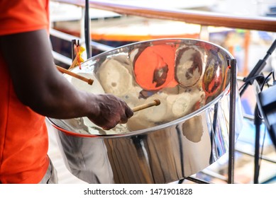 man is playing on a steel drums at cruise ship open deck