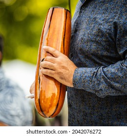 Man Playing Percussion Instrument In Salsa Band.