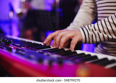 man is playing  piano in band - Shutterstock ID 598799270