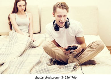 Man Is Playing Playstation Computer Game Woman Girlfriend Is Angry For Him