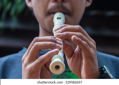 A Man Playing Recorder