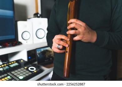 A man playing and recording the sound of native American style flute. Close up hands. High quality photo - Shutterstock ID 2256252887