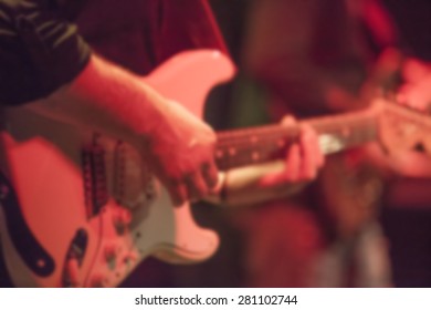 Man Playing Rock Guitar On Concert,blurred Rock Background