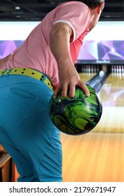 Man Playing Ten Pin Bowling With Green Bowling Ball