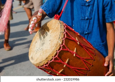 Man playing thai drum outdoors - Shutterstock ID 232019986
