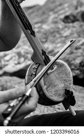 A Man Playing Traditional Rebab