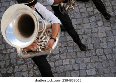 Man playing tuba in a street orchestra