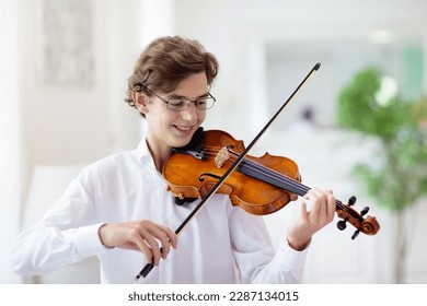 Man playing violin. Classical music instrument. Teenage boy practicing viola. Teenager art school student.