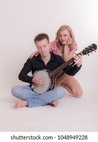 Man Plays A Banjo For A Girl