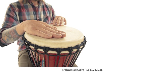 Man plays ethnic drum darbuka percussion, close up musician isolated on white studio background. Male hands tapping djembe, bongo in rhythm. Musical handmade instruments, world culture sound.