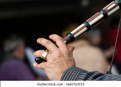 Man Plays A Three-hole Wood And Bone Flute With One Hand