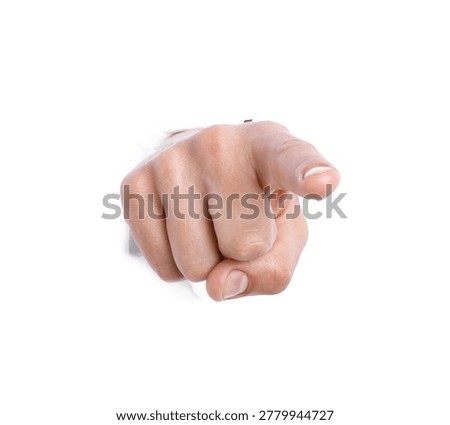 Man pointing at camera through hole in white paper, closeup