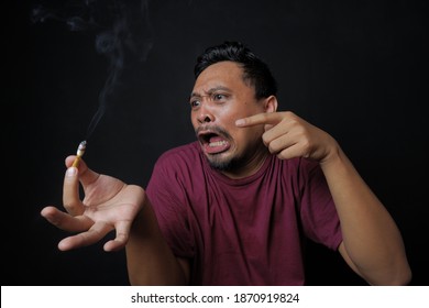 Man Pointing Cigarette With Angry Reaction, Funny And Rage Asian Guy Holding Cigarette In The Hand