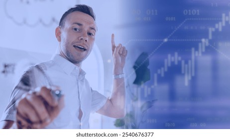 Man pointing at digital financial chart, smiling, wearing white shirt. Business, finance, and technology theme with graphs and data overlay. Business finance concept image. - Powered by Shutterstock