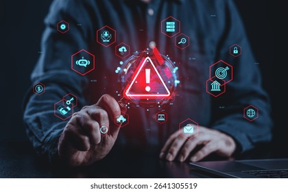 Man pointing at digital warning icon with cybersecurity threat symbols in futuristic style on dark background, concept of data protection and risk