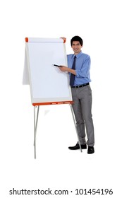 Man Pointing At Flip Chart With Pen