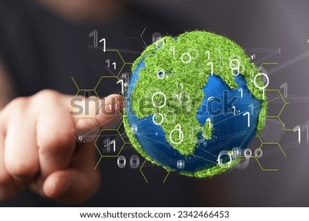 A man pointing at a grassy Earth. the concept of green energy