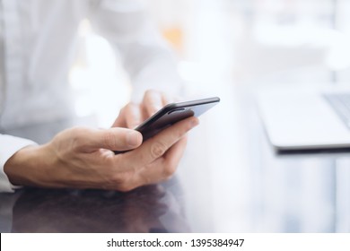Man pointing on smartphone screen, chatting in social networks, meeting website, searching internet, sending sms, using text messenger or online banking. Close up of male hands