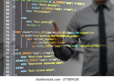 man pointing on virtual screen with website programming code (There is no potentially infringes on intellectual property rights)