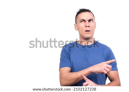 Man pointing to the side with confused expression