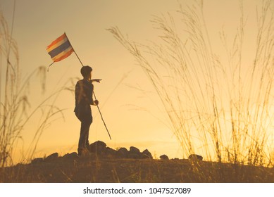 The Man Is Pointing To Sky And Holding Thai Flag In Warm Photo Filter Means Leading To Success In Life Or Business