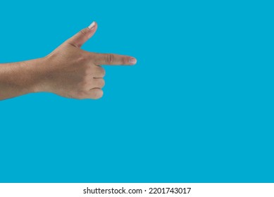 Man pointing at something on isolated blue background. closeup of handmen's fingers.