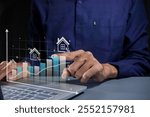 Man pointing to a virtual graph. House price rising up or real estate property growth concept.