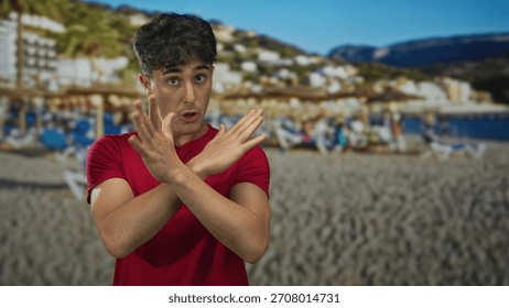 Man points finger at camera in a studio with beach backdrop and sand umbrellas; determination resolve.