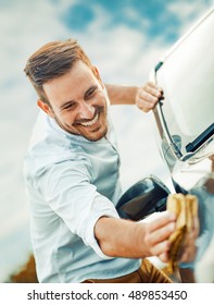 A Man Polishing Car With Microfiber Cloth.