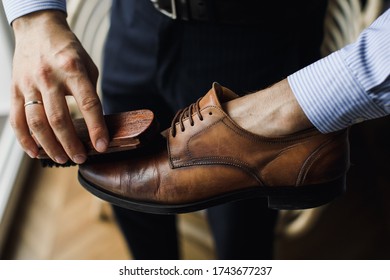 Man polishing leather shoes with brush at home - Shutterstock ID 1743677237
