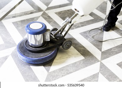 Man Polishing Marble Floor In Modern Office Building