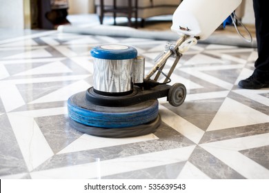 man polishing marble floor in modern office building