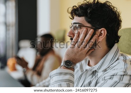 The man ponders, striving to devise a solution for the challenging task at hand.