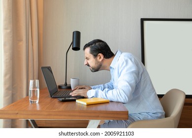 Man With A Poor Eyesight Working In His Laptop, Struggling To See