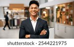 Man, portrait and arms crossed of manager in hotel, customer service and friendly concierge. Male person, lobby reception and proud assistance in front desk, hospitality worker and lodge receptionist