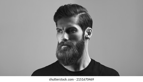 Man Portrait. Fashion Model With Stylish Hair And Beard. Man With Long Beard And Moustache On Serious Face Black And White Concept Photo