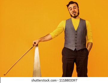 Man Portrait Holding Musical Saw With Funny Expression On His Face