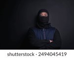 Man, portrait and mask of robber in studio, burglar and criminal or black background for thief. Male person, balaclava and disguise for bad guy on mockup space, danger and gangster for illegal action