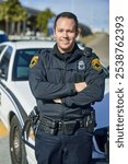 Man, portrait and officer with arms crossed, outdoor and uniform for responsibility in city. Male person, law enforcement and cop for public service of security, fearless and authority in traffic