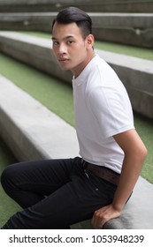 Man Portrait, Smart Casual Man, Confident Handsome Man Sitting In City Environment; Young Adult South East Asian Man Model With Tan Skin And Short Hair